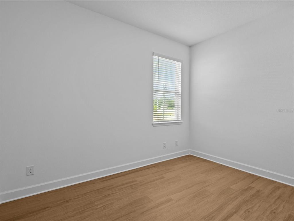 8018 Colby Circle Orlando, FL 32817 - Photo 17 of 32 wooden floor in an empty room with a window