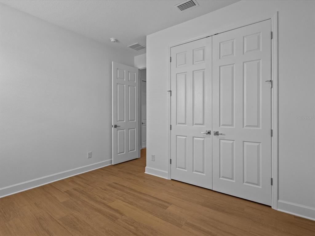 8018 Colby Circle Orlando, FL 32817 - Photo 19 of 32 a view of an empty room with wooden floor