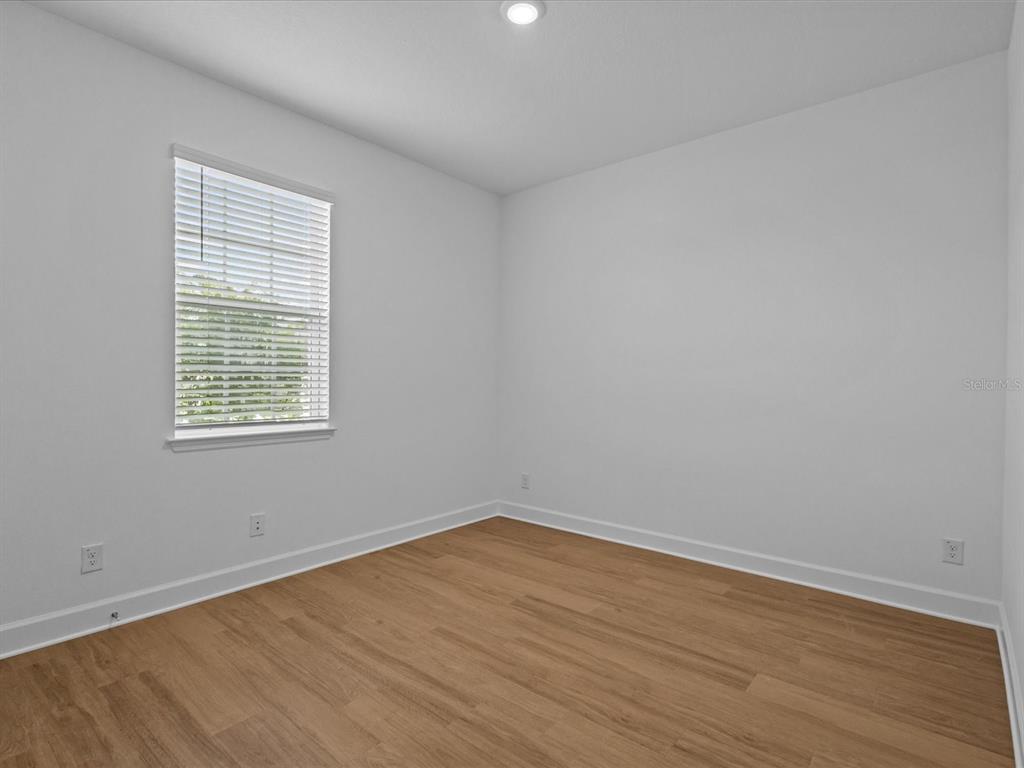 8018 Colby Circle Orlando, FL 32817 - Photo 22 of 32 wooden floor in an empty room with a window
