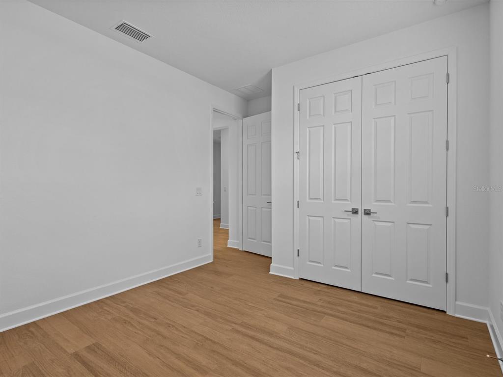 8018 Colby Circle Orlando, FL 32817 - Photo 25 of 32 a view of an empty room with wooden floor