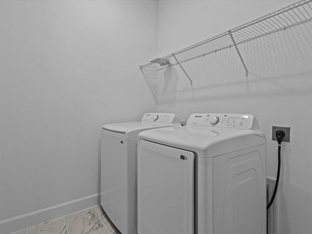 8018 Colby Circle Orlando, FL 32817 - Photo 26 of 32 a utility room with dryer and washer