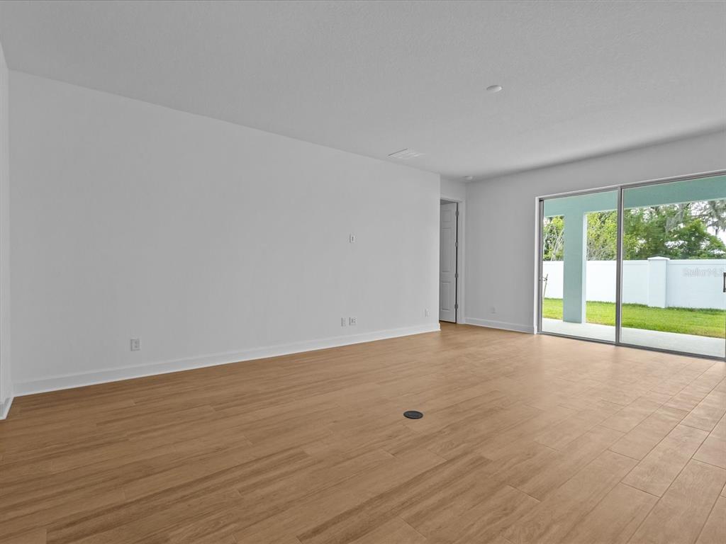 8018 Colby Circle Orlando, FL 32817 - Photo 30 of 32 a view of an empty room with wooden floor and a window