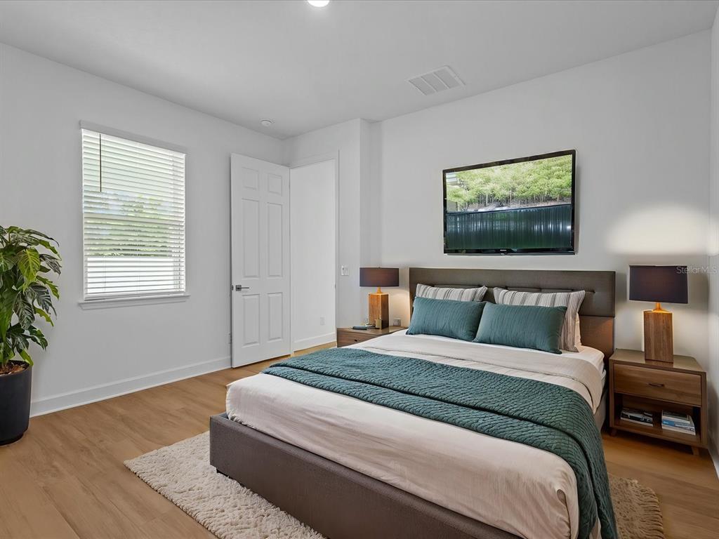 8018 Colby Circle Orlando, FL 32817 - Photo 10 of 32 a bedroom with a bed and a potted plant