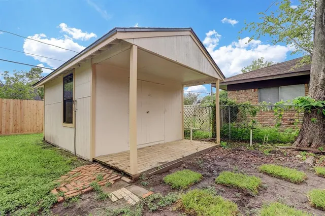 a backyard of a house with plants and outdoor seating