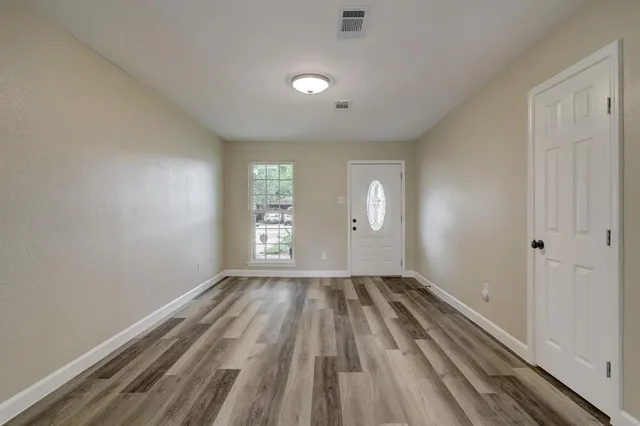 wooden floor in an empty room with a window