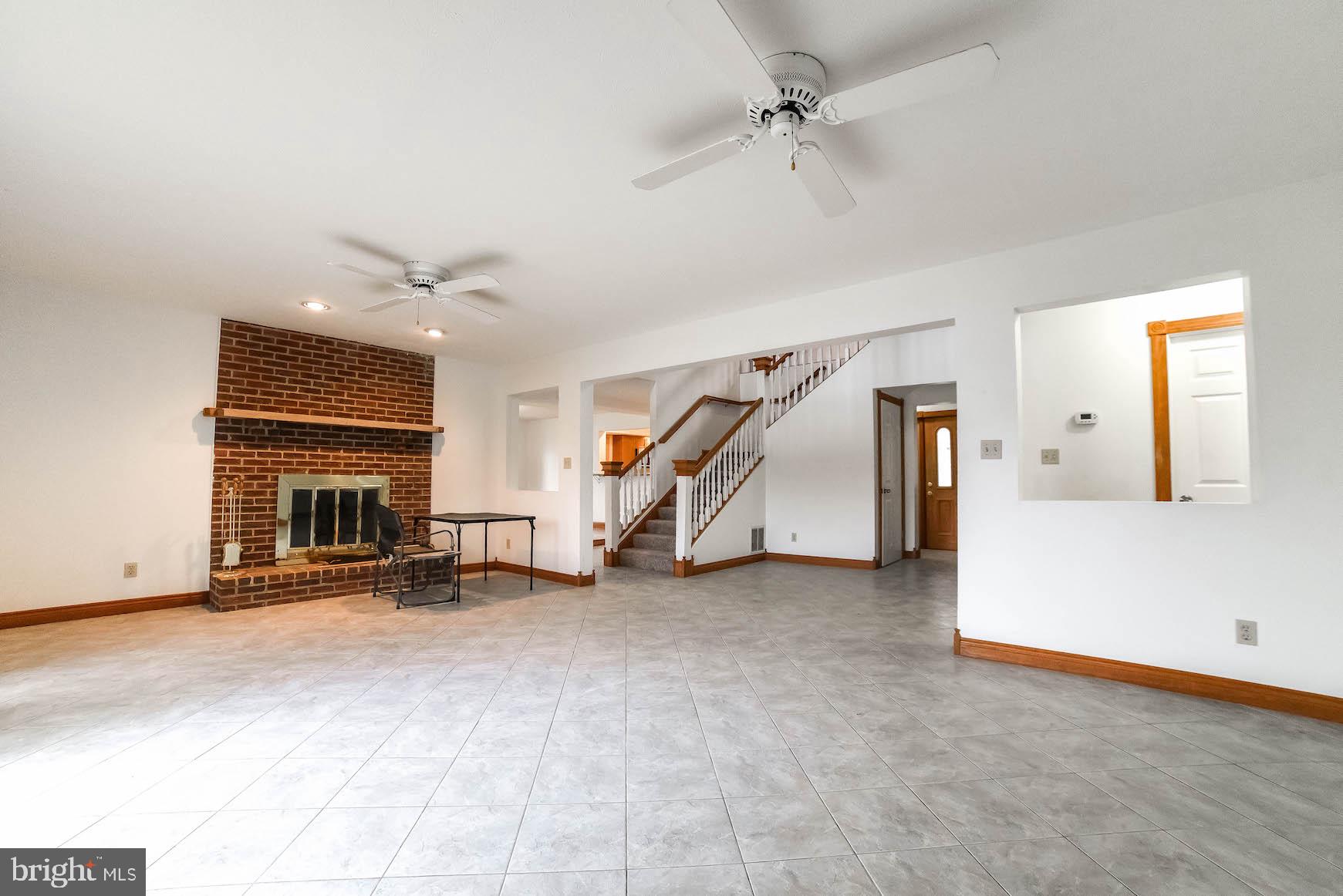 17747 St Inigoes Road St. Inigoes, MD 20684 - Photo 18 of 51 Large open living are with a fireplace.