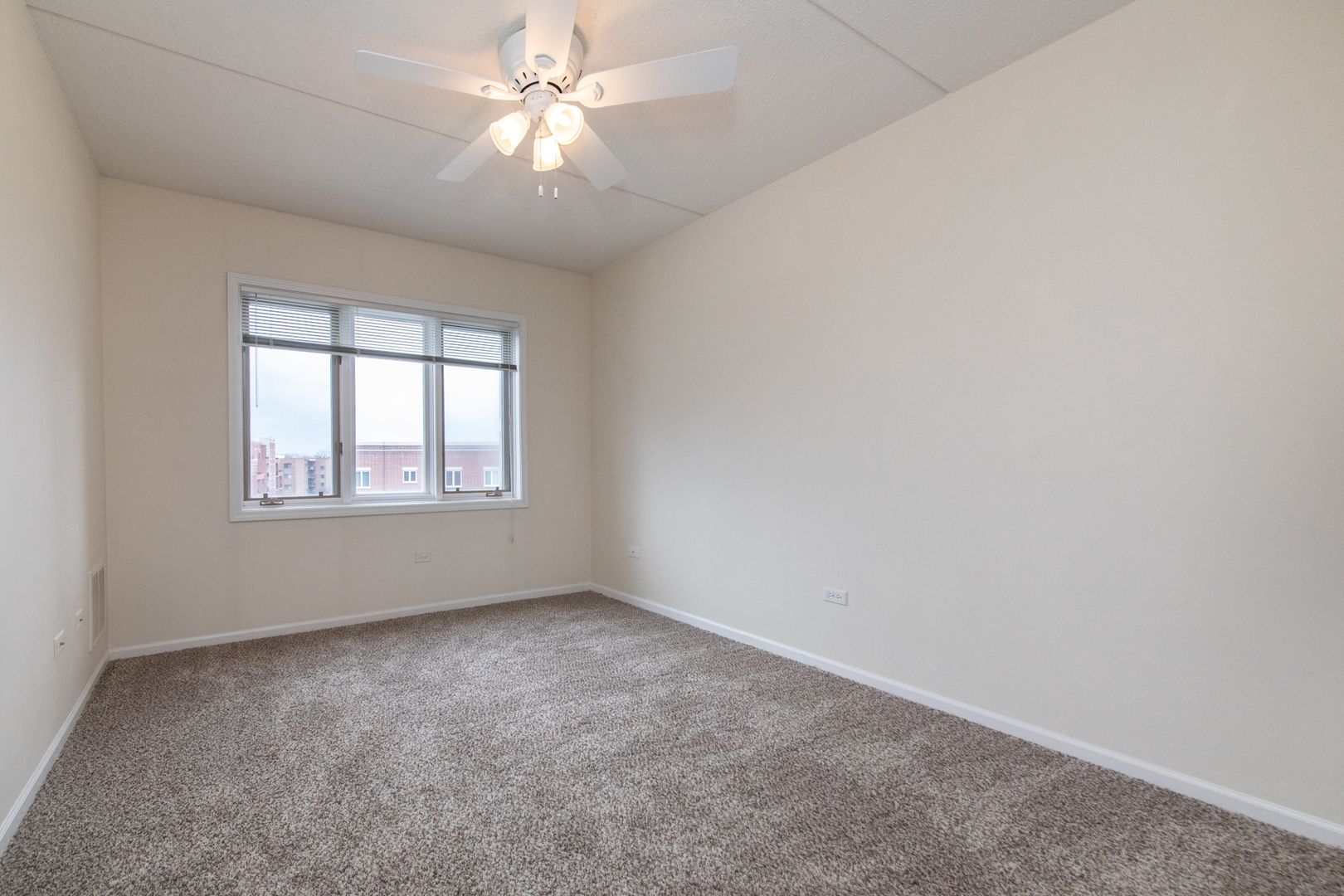 650 South River Road, Unit 601 Des Plaines, IL 60016 - Photo 13 of 20 an empty room with a window and a fan