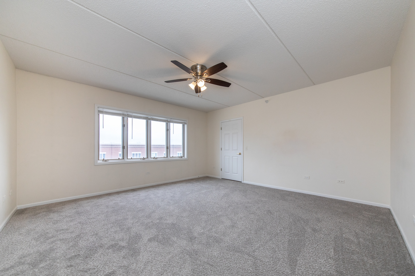 650 South River Road, Unit 601 Des Plaines, IL 60016 - Photo 15 of 20 an empty room with fan and windows