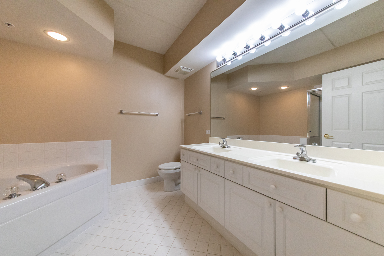 650 South River Road, Unit 601 Des Plaines, IL 60016 - Photo 18 of 20 a spacious bathroom with a double vanity sink a toilet and a large mirror