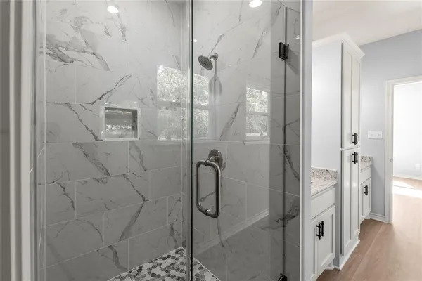 a bathroom with a glass shower door