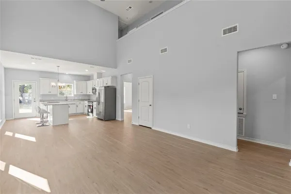 a view of kitchen with refrigerator and window