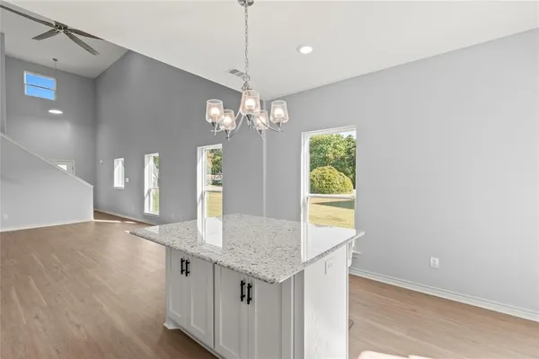 a room with kitchen island and wooden floor