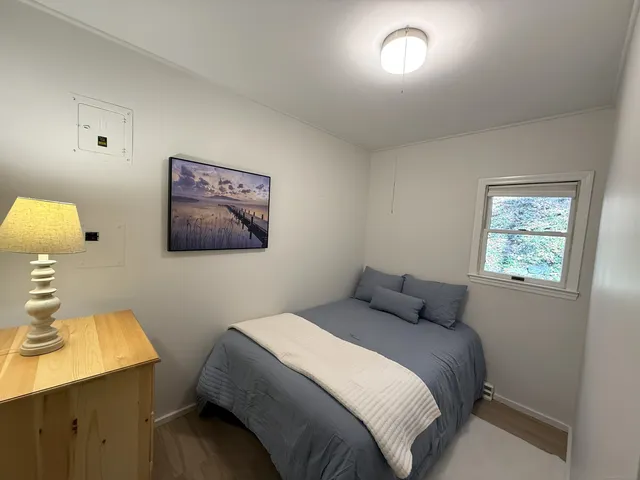 a bedroom with a bed and a lamp on table