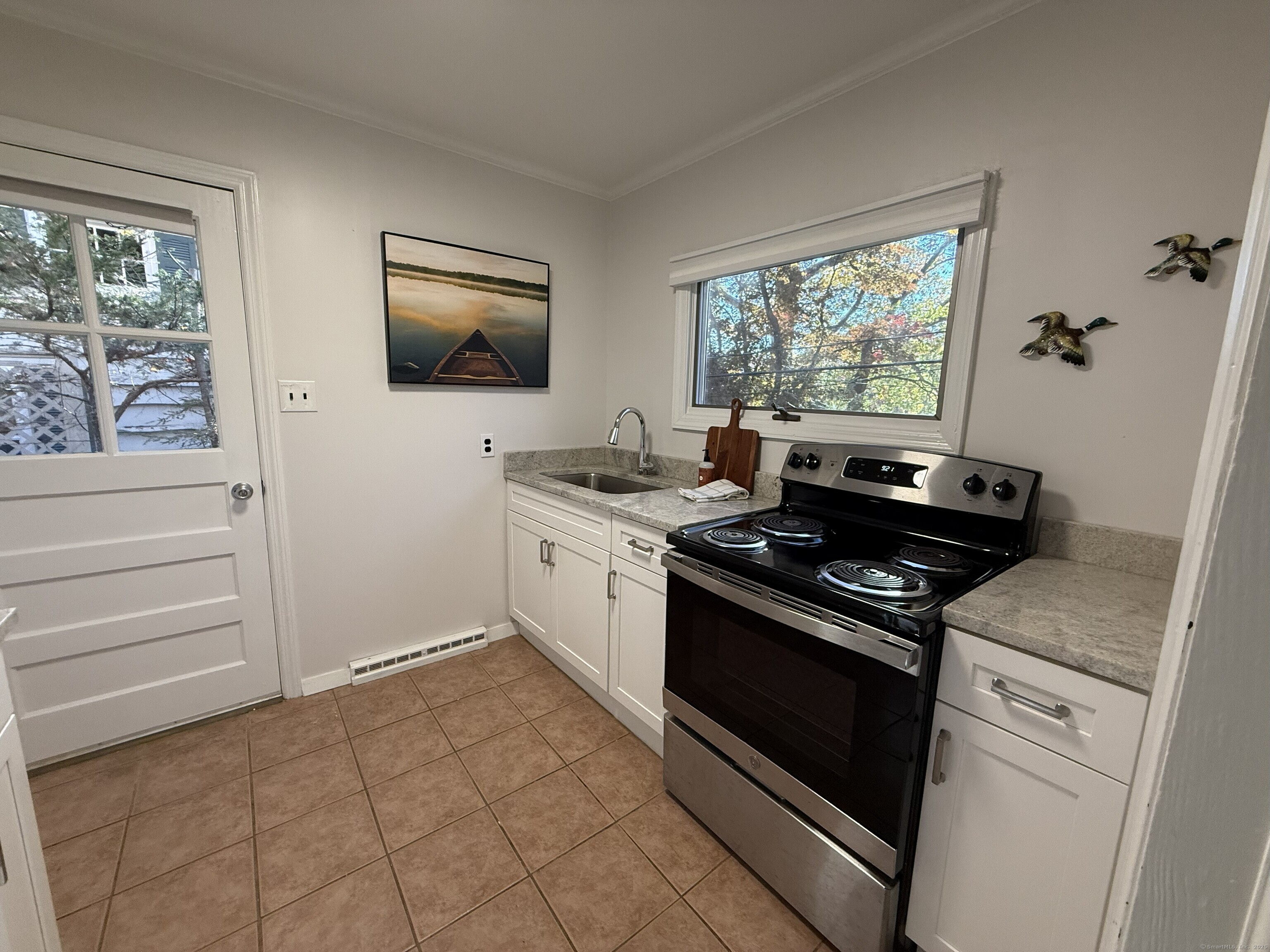 11 Bogus Hill Road New Fairfield, CT 06812 - Photo 10 of 13 a kitchen with a stove and a window
