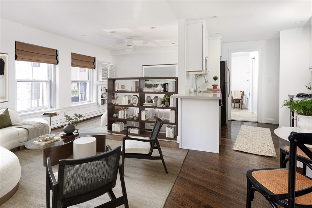 a dining room with furniture and wooden floor