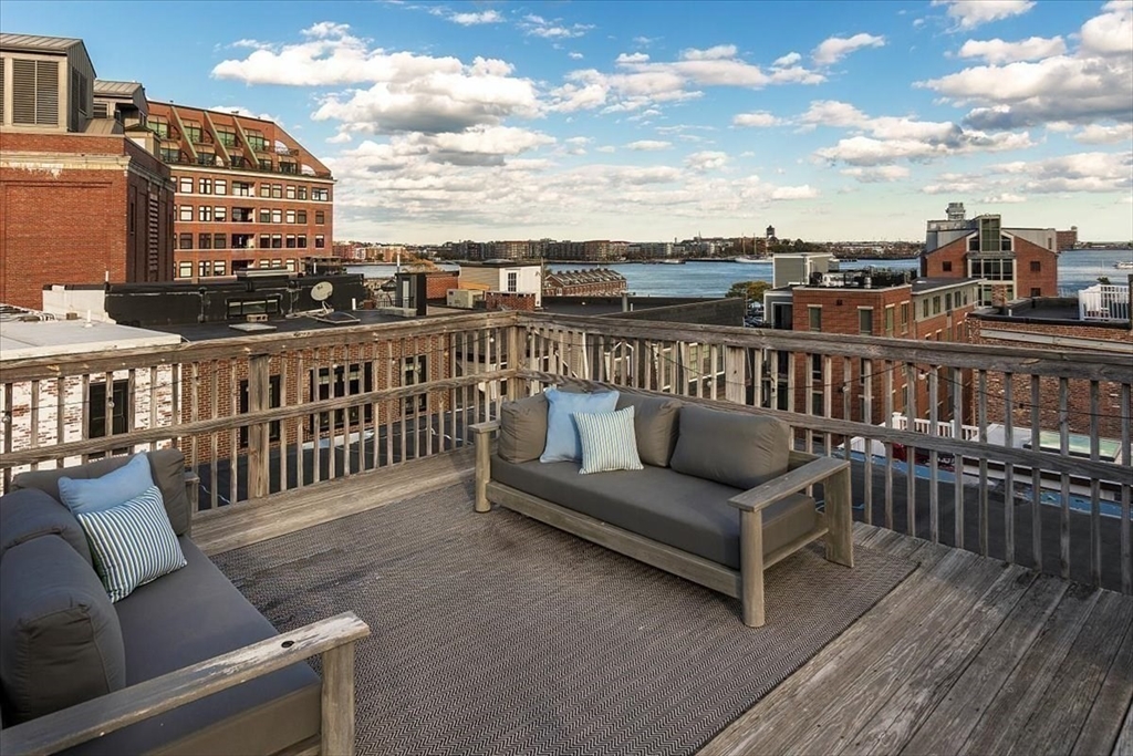 21 Moon Street, Unit 2 Boston, MA 02113 - Photo 11 of 19 a balcony with wooden floor and city view