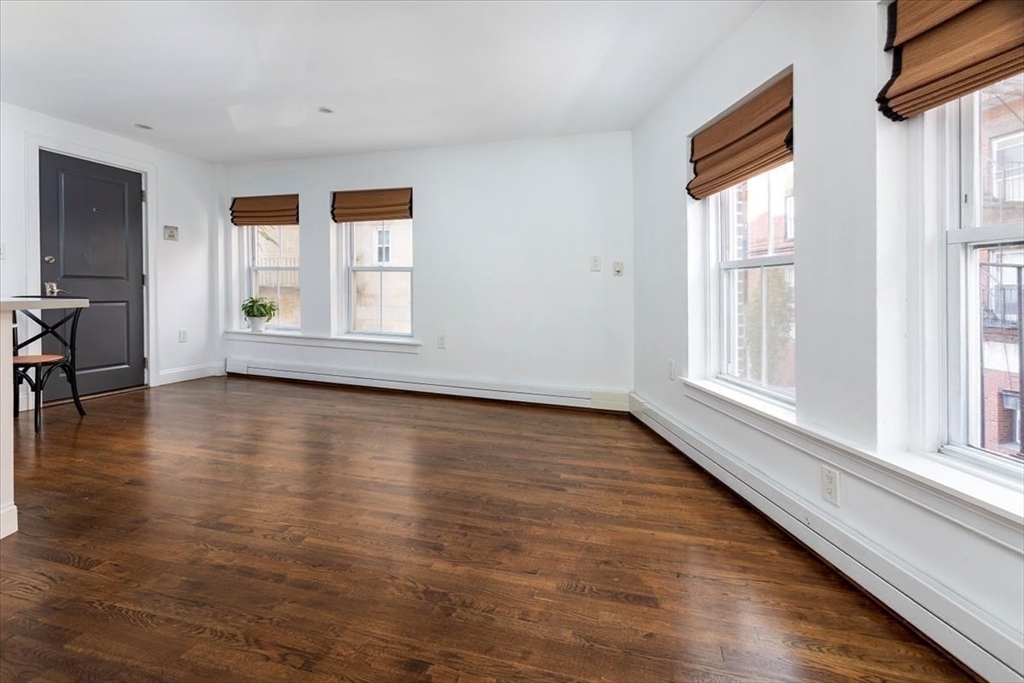 21 Moon Street, Unit 2 Boston, MA 02113 - Photo 12 of 19 wooden floor in an empty room with a window