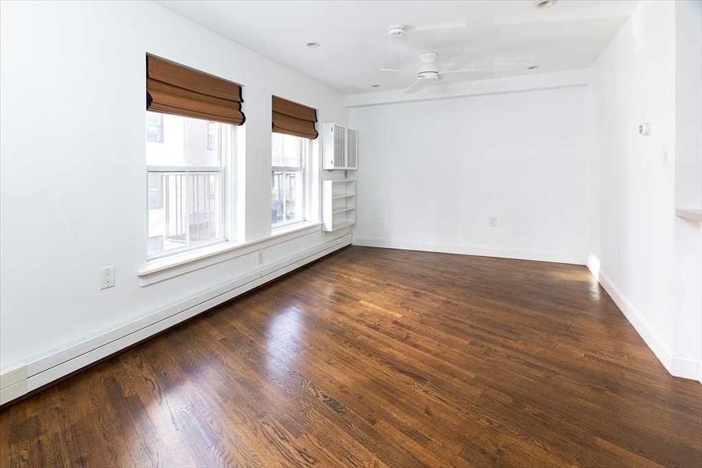 21 Moon Street, Unit 2 Boston, MA 02113 - Photo 14 of 19 a view of an empty room with wooden floor and a window