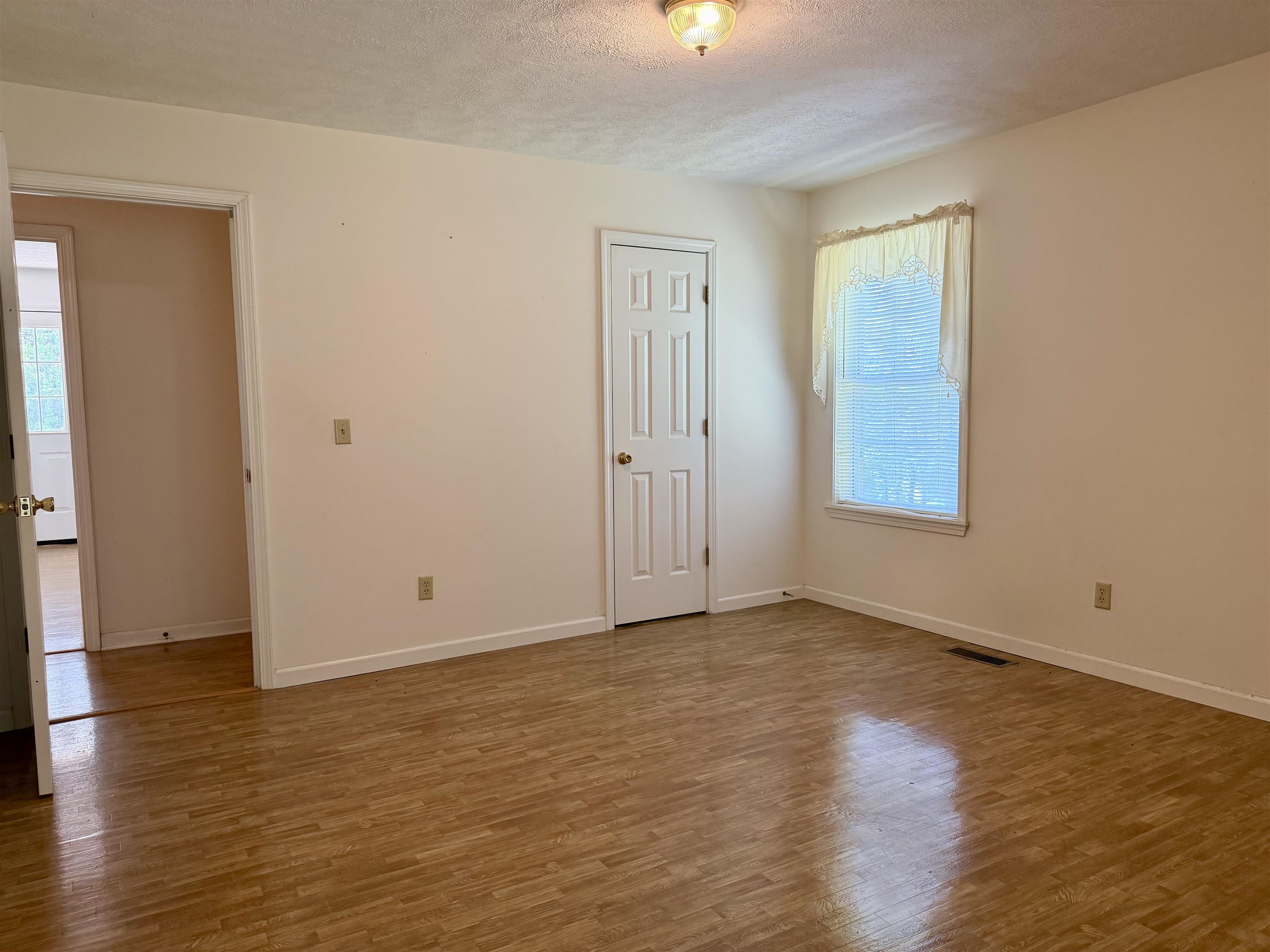 3010 Powell Chapel Road Middleton, TN 38052 - Photo 17 of 28 an empty room with wooden floor and windows