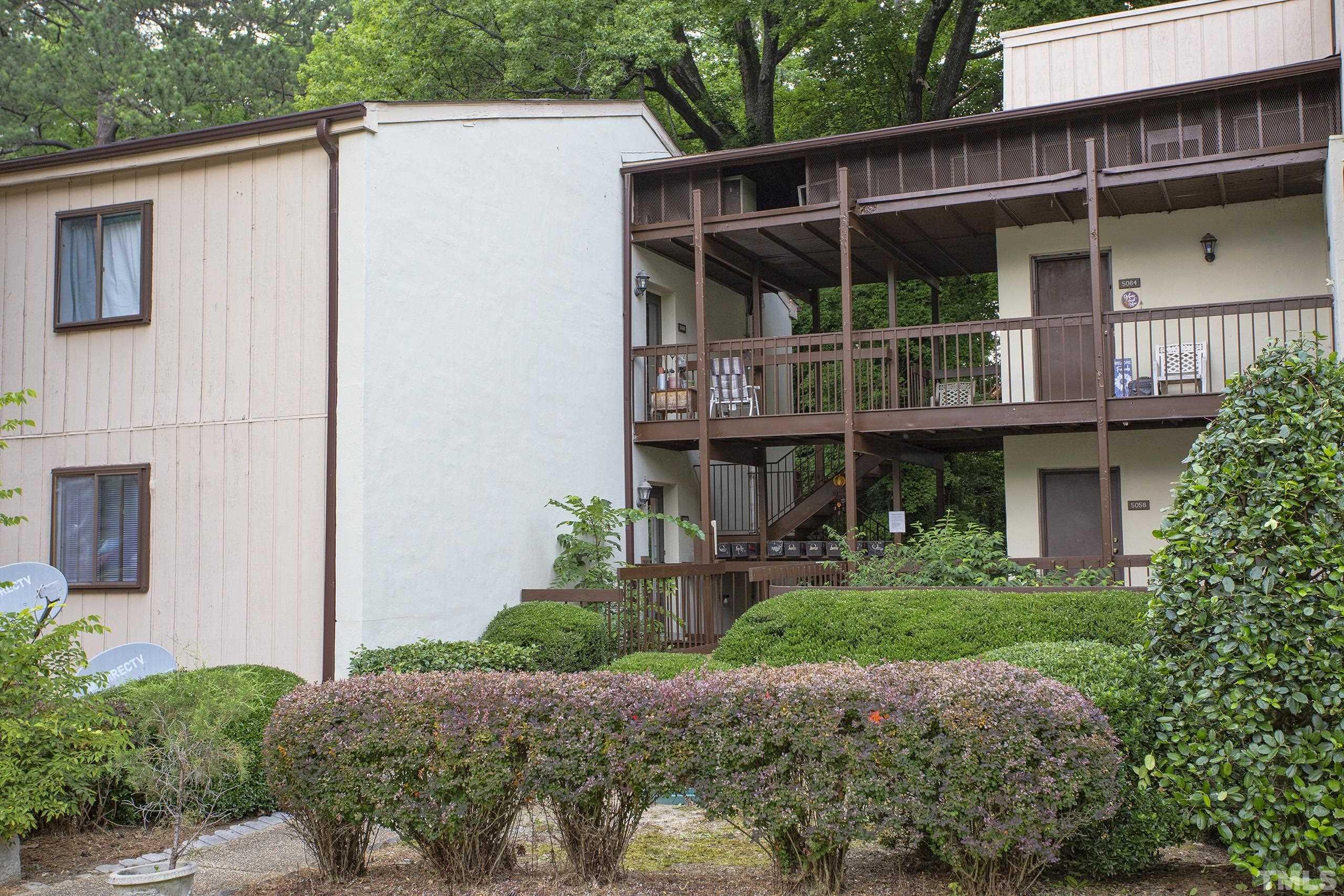 5060 Flint Ridge Place, Unit 5060 Raleigh, NC 27609 - Photo 1 of 29 a view of a house with potted plants and a yard