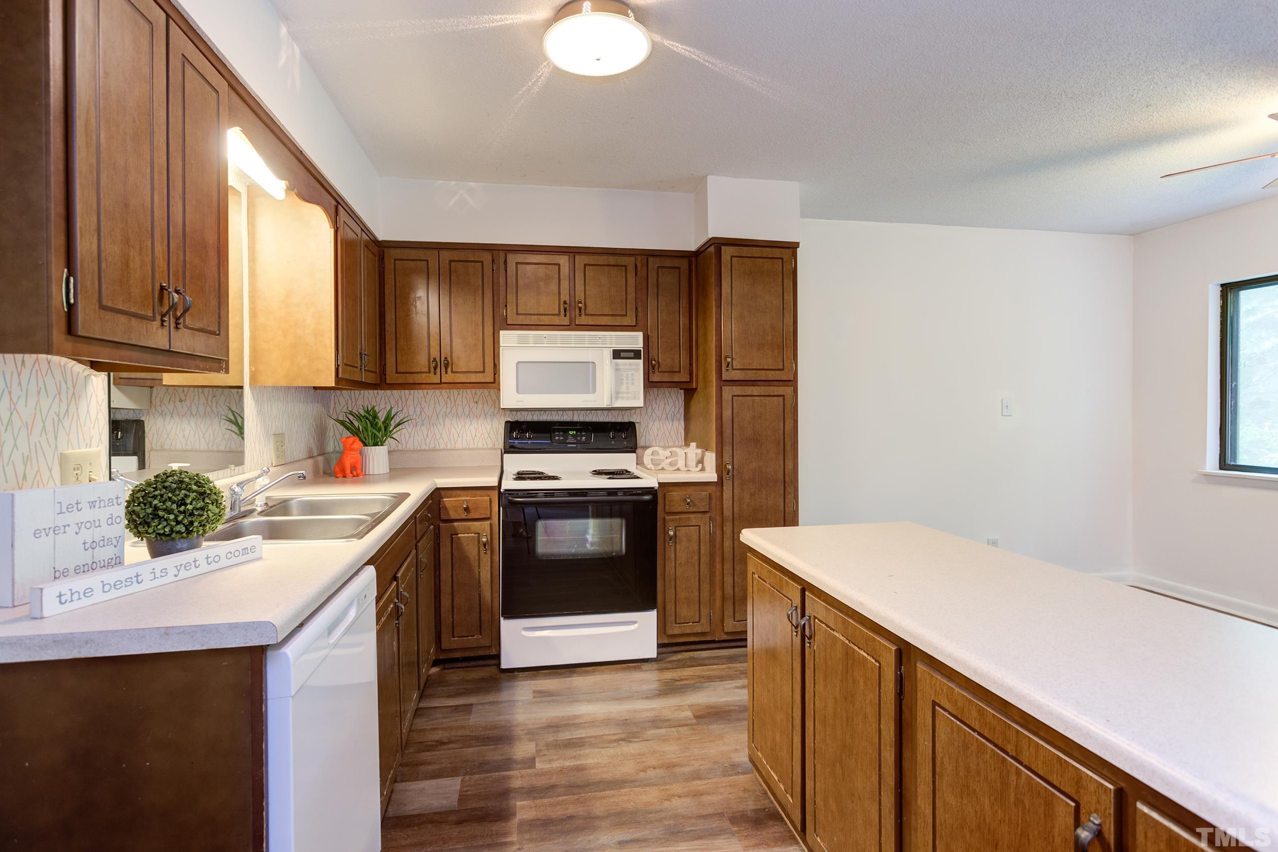 5060 Flint Ridge Place, Unit 5060 Raleigh, NC 27609 - Photo 11 of 29 a kitchen with a sink stove and refrigerator