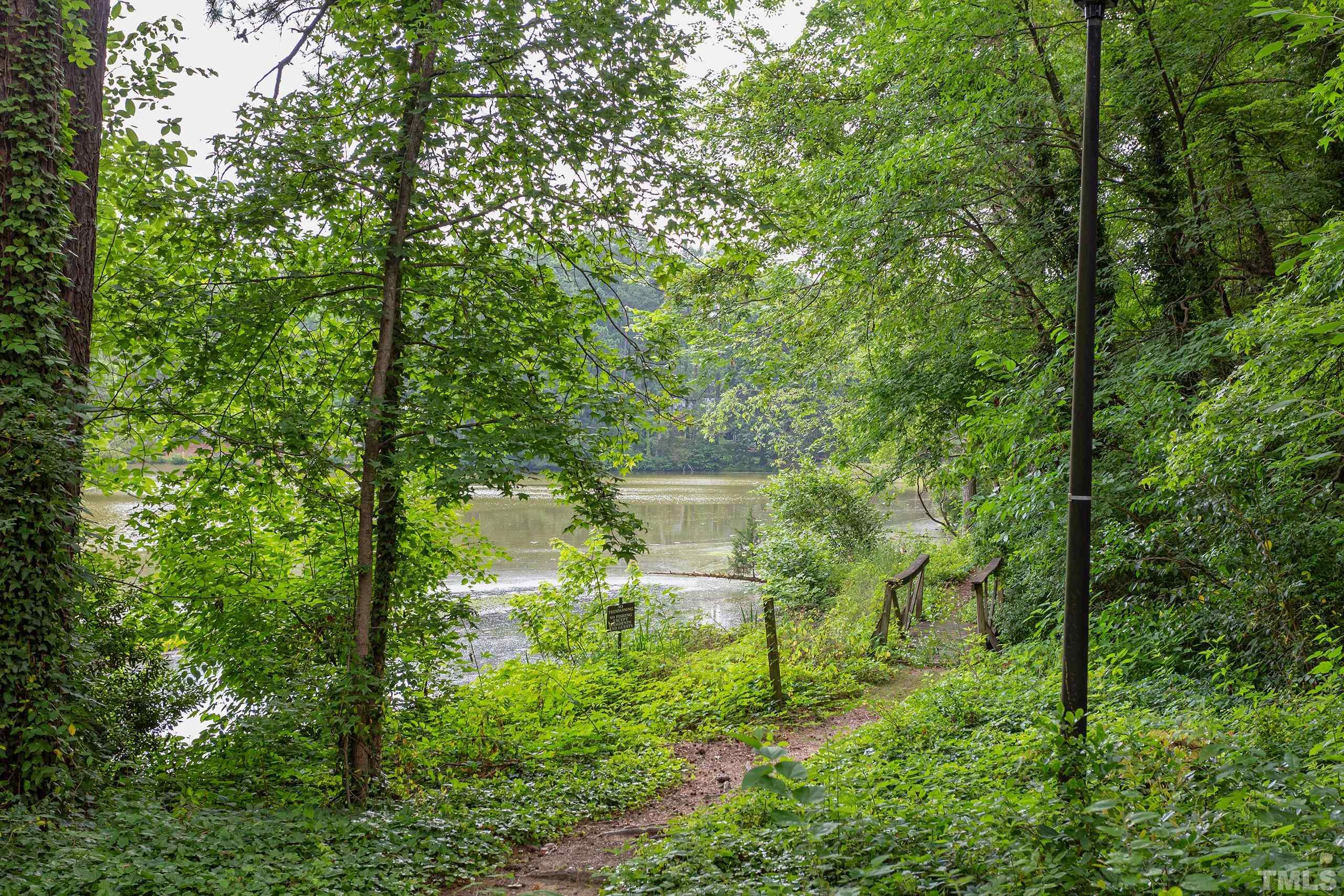 5060 Flint Ridge Place, Unit 5060 Raleigh, NC 27609 - Photo 27 of 29 a view of a garden with plants and large trees