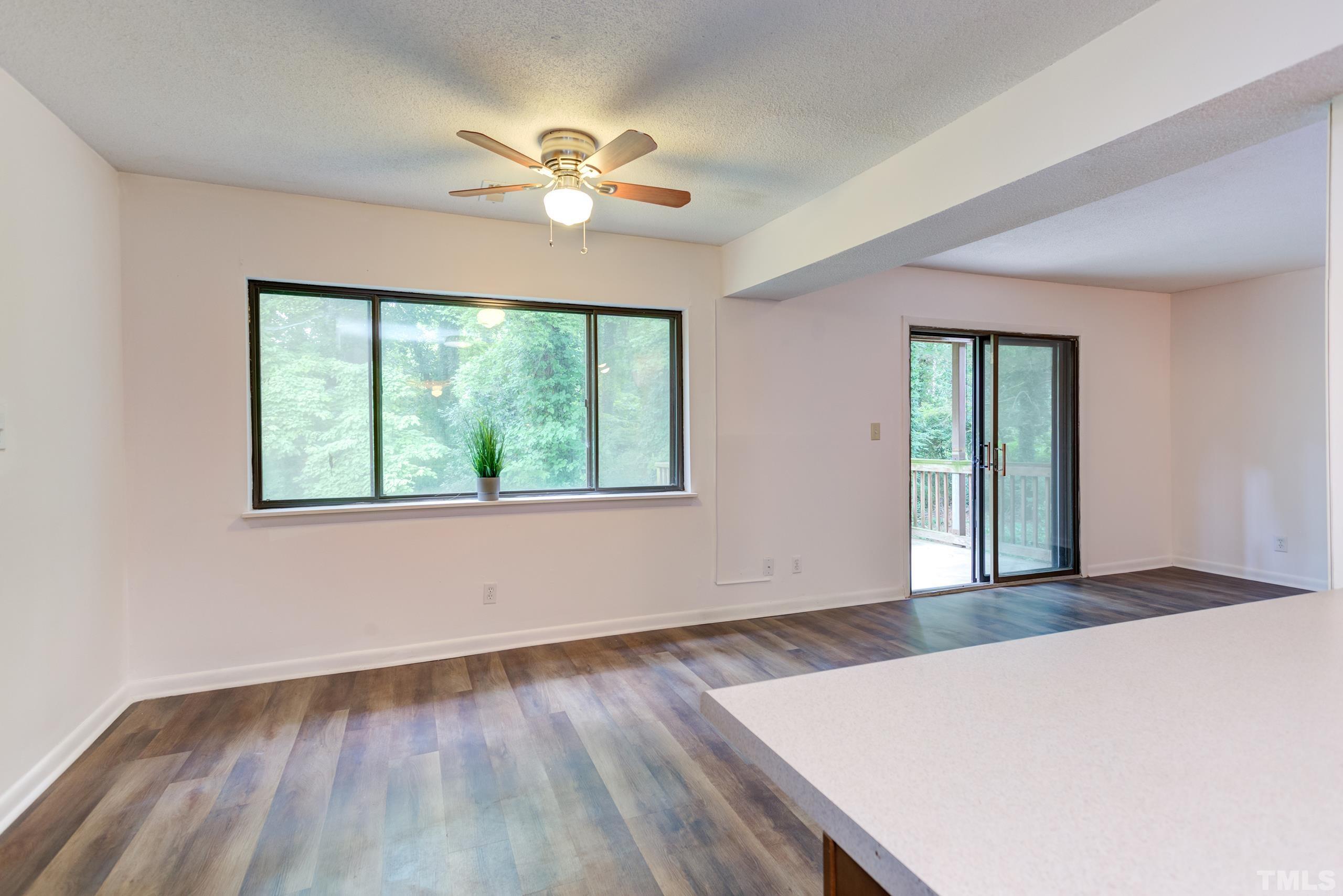 5060 Flint Ridge Place, Unit 5060 Raleigh, NC 27609 - Photo 6 of 29 a view of an empty room with wooden floor and a window
