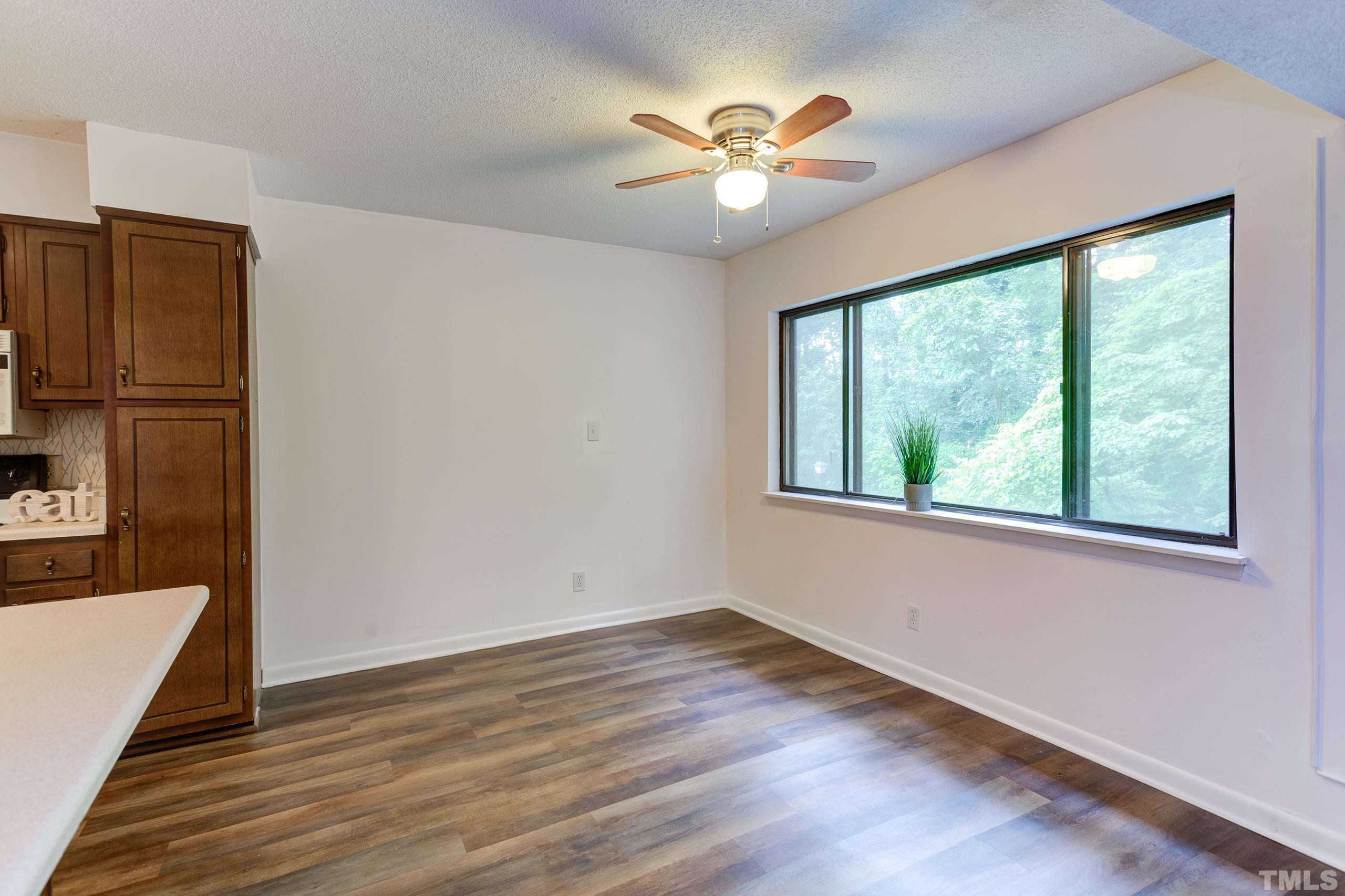 5060 Flint Ridge Place, Unit 5060 Raleigh, NC 27609 - Photo 8 of 29 a view of empty room with wooden floor and fan