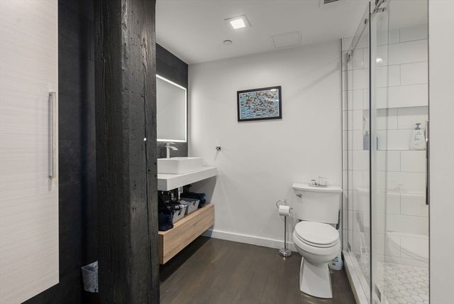 a bathroom with a toilet a sink and shower
