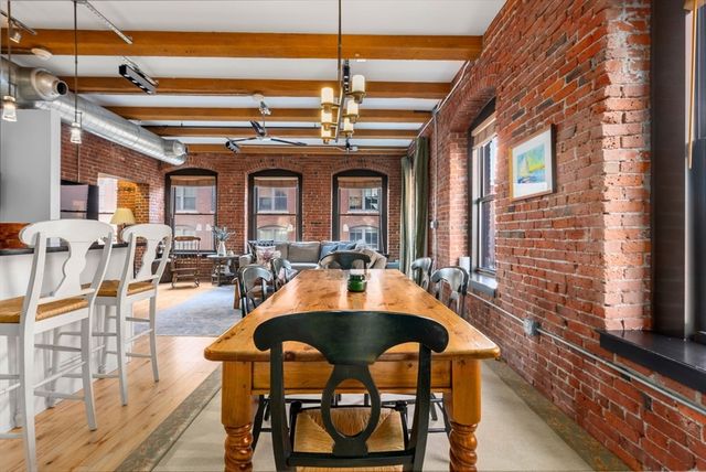 a dining room with furniture and a chandelier