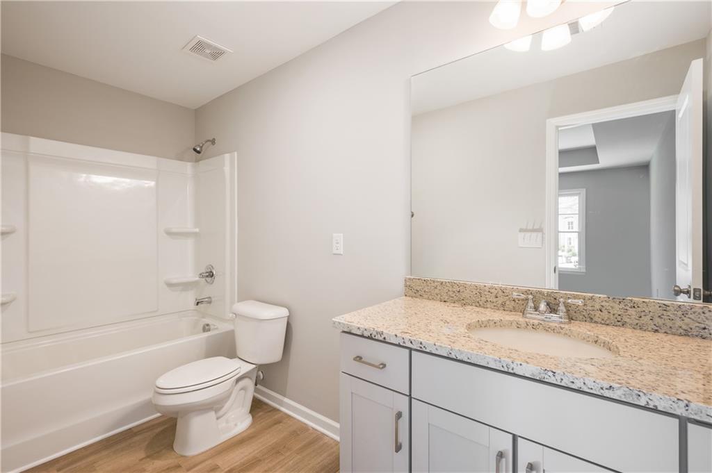 2826 Laurel Ridge Circle East Point, GA 30344 - Photo 23 of 25 a bathroom with a granite countertop sink toilet and shower