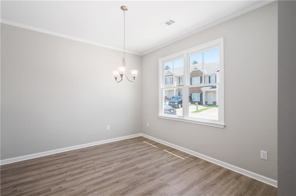 2826 Laurel Ridge Circle East Point, GA 30344 - Photo 5 of 25 a view of an empty room with wooden floor and a window