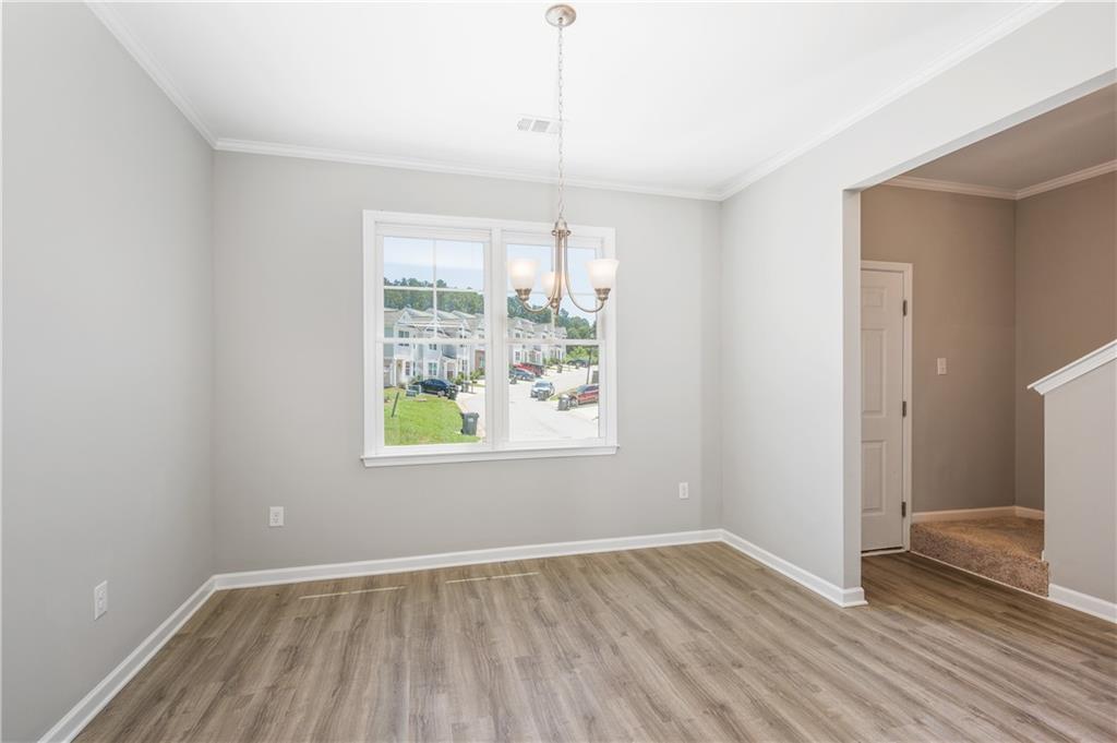 2826 Laurel Ridge Circle East Point, GA 30344 - Photo 6 of 25 a view of an empty room with wooden floor and a window