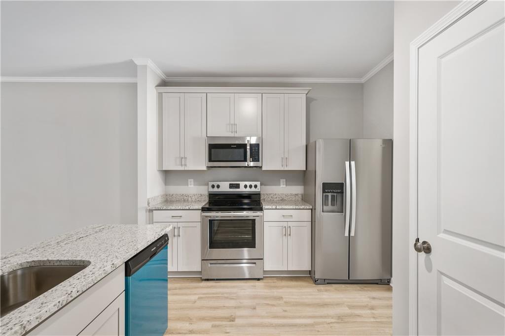 2826 Laurel Ridge Circle East Point, GA 30344 - Photo 8 of 25 a kitchen with stainless steel appliances granite countertop a refrigerator stove and sink