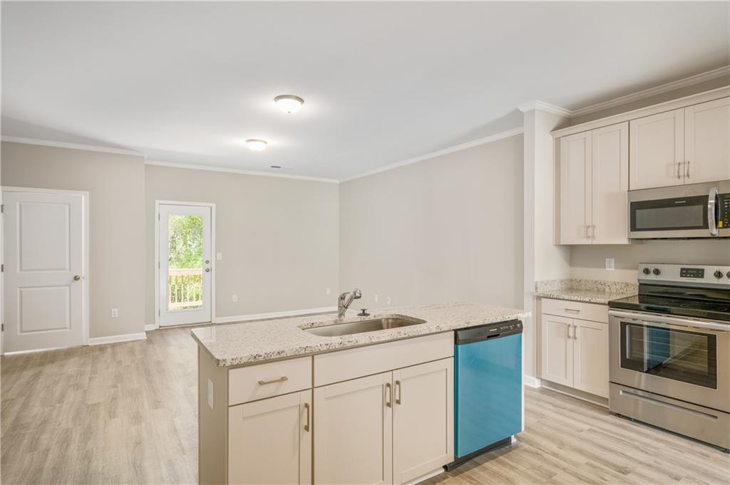 2826 Laurel Ridge Circle East Point, GA 30344 - Photo 9 of 25 a kitchen with granite countertop white cabinets and white appliances