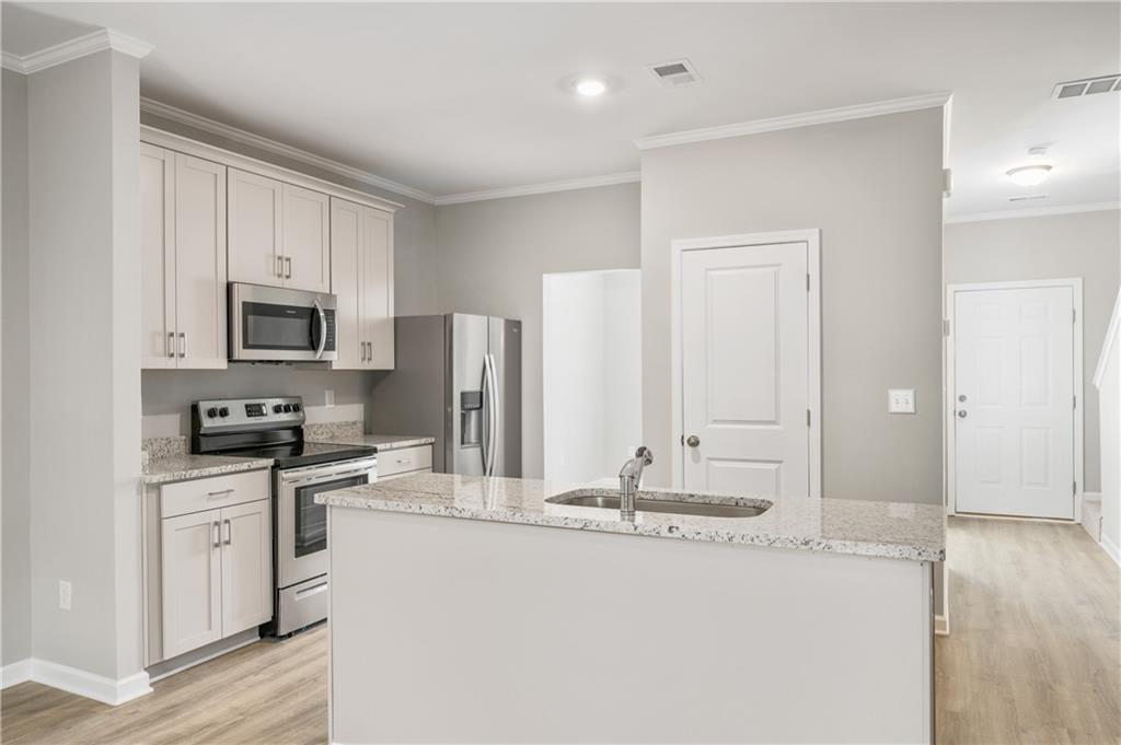 2826 Laurel Ridge Circle East Point, GA 30344 - Photo 10 of 25 a kitchen with stainless steel appliances granite countertop a sink stove and refrigerator