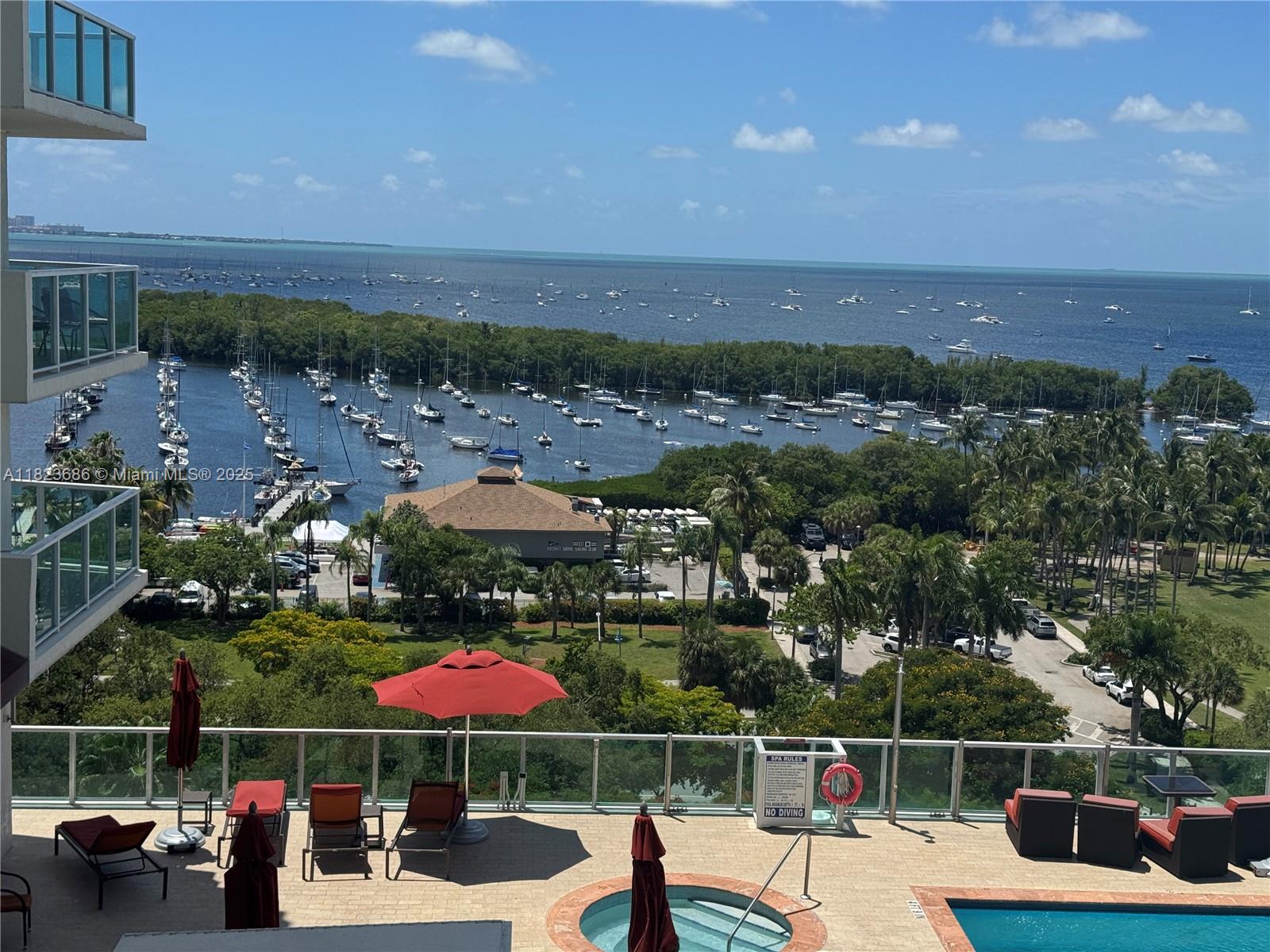 2889 McFarlane Road, Unit 1016 Miami, FL 33133 - Photo 1 of 12 an outdoor space with furniture and umbrella