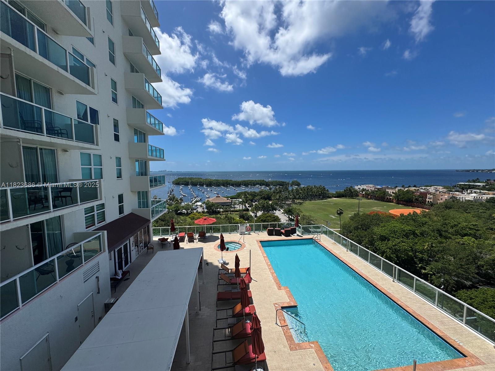 2889 McFarlane Road, Unit 1016 Miami, FL 33133 - Photo 2 of 12 a view of swimming pool from a balcony