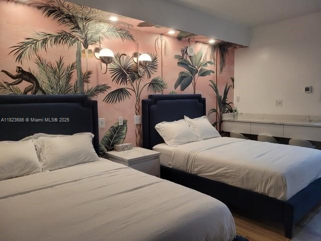 2889 McFarlane Road, Unit 1016 Miami, FL 33133 - Photo 8 of 12 a bedroom with two beds and a night stand