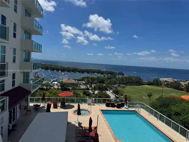 a view of a balcony with a yard