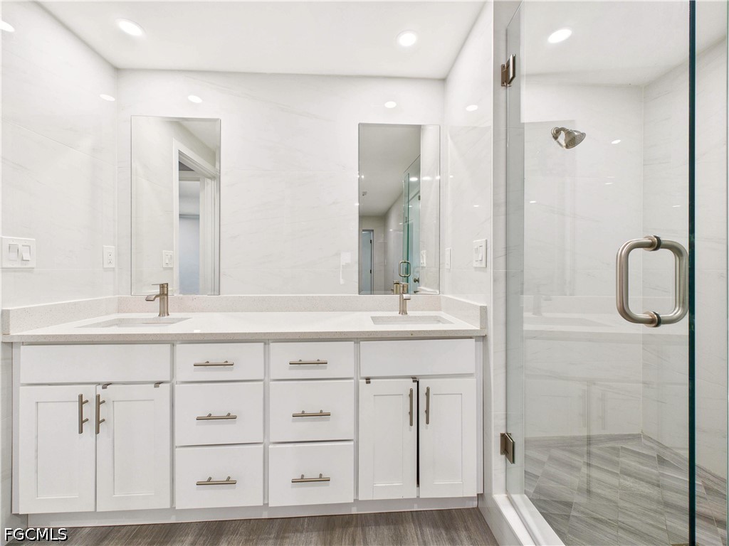 567 13th Street North Naples, FL 34102 - Photo 12 of 23 a bathroom with double vanity sink and a mirror