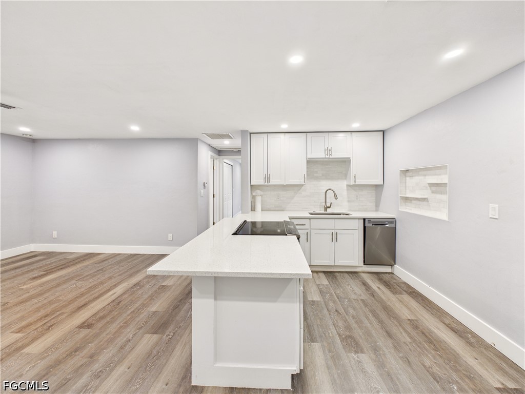 567 13th Street North Naples, FL 34102 - Photo 19 of 23 a open kitchen with white cabinets a sink and wooden floor