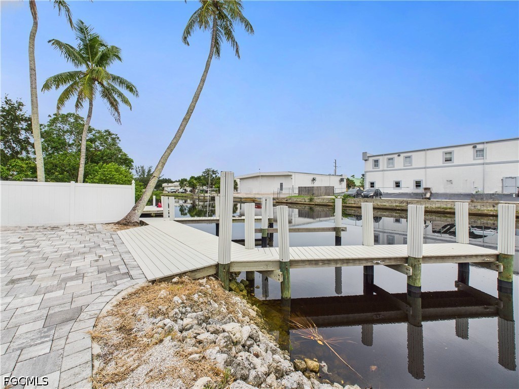 567 13th Street North Naples, FL 34102 - Photo 20 of 23 a view of a swimming pool with a table and chairs