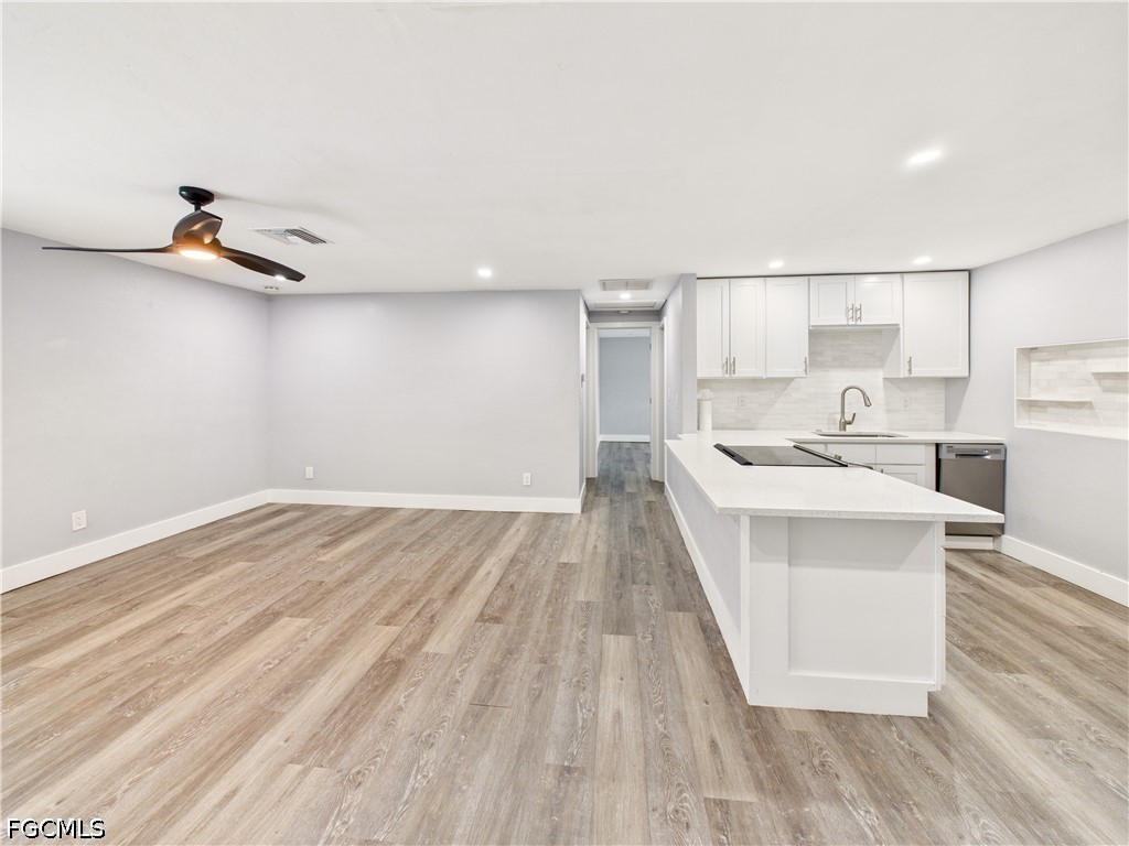567 13th Street North Naples, FL 34102 - Photo 2 of 23 a kitchen with kitchen island a sink and wooden floor
