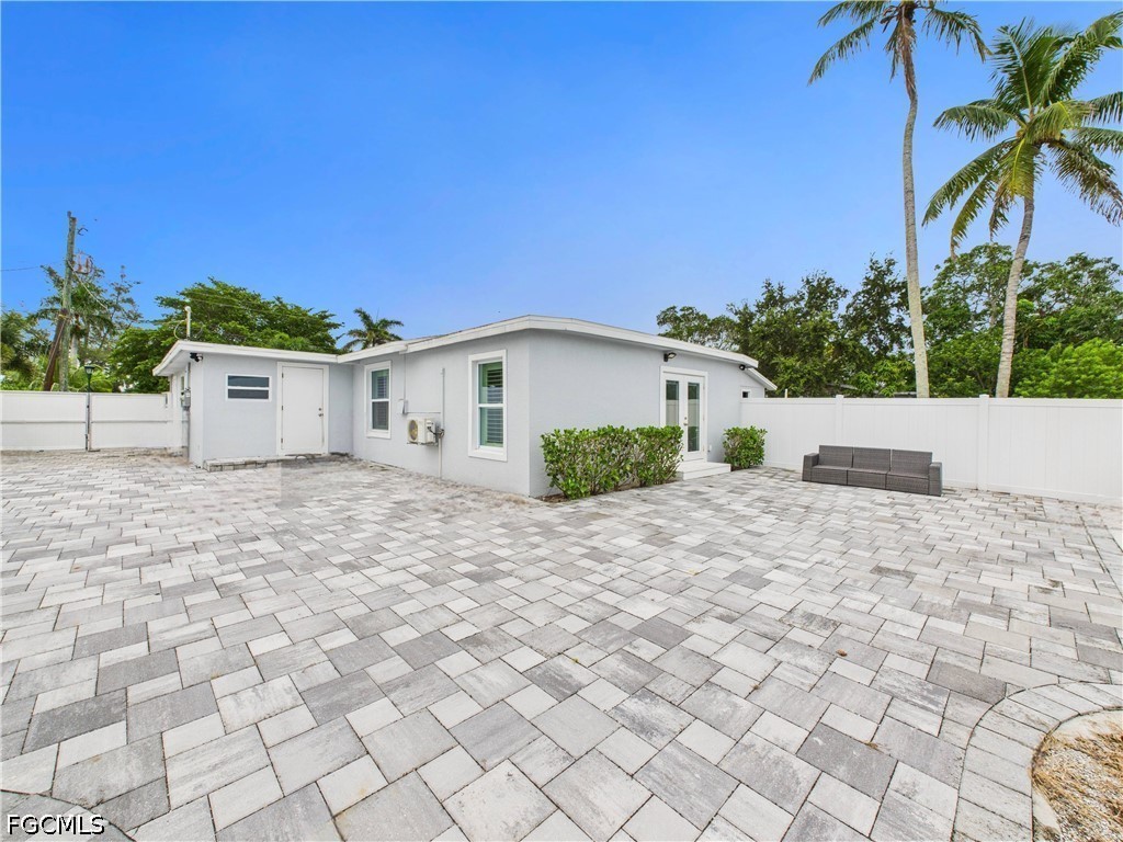 567 13th Street North Naples, FL 34102 - Photo 21 of 23 a view of white house with a yard and palm trees