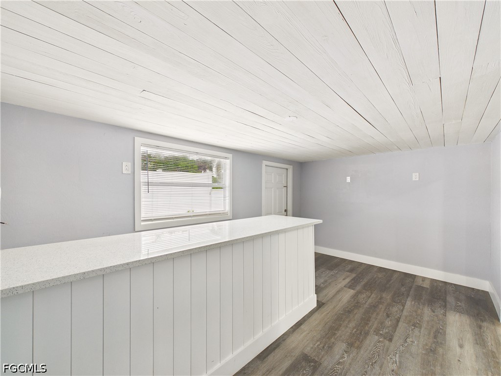 567 13th Street North Naples, FL 34102 - Photo 6 of 23 a view of an empty room with wooden floor and a window