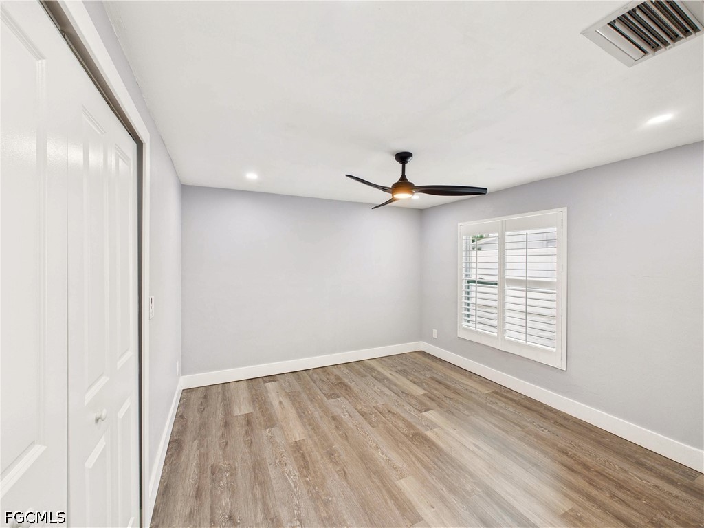 567 13th Street North Naples, FL 34102 - Photo 8 of 23 a view of empty room with wooden floor and fan