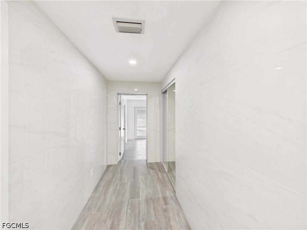 567 13th Street North Naples, FL 34102 - Photo 9 of 23 a view of a hallway with wooden floor