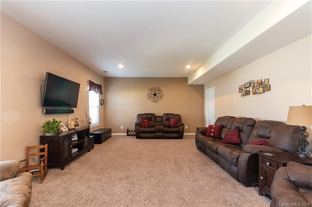 10937 Tailwater Street Davidson, NC 28036 - Photo 12 of 34 a living room with furniture and a flat screen tv