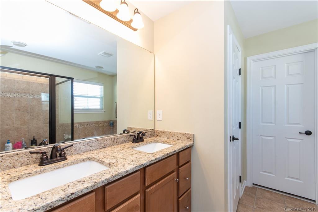 10937 Tailwater Street Davidson, NC 28036 - Photo 17 of 34 a bathroom with a granite countertop sink and a mirror